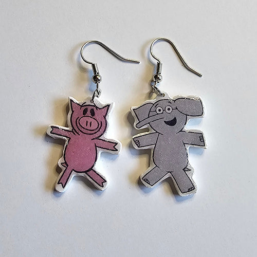Piggy and Elephant dangle silver dangle earrings made out of polymer clay on a white background. 
