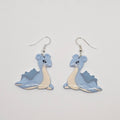 White gold dangle earrings of pokemon Lapras made out of polymer clay.
