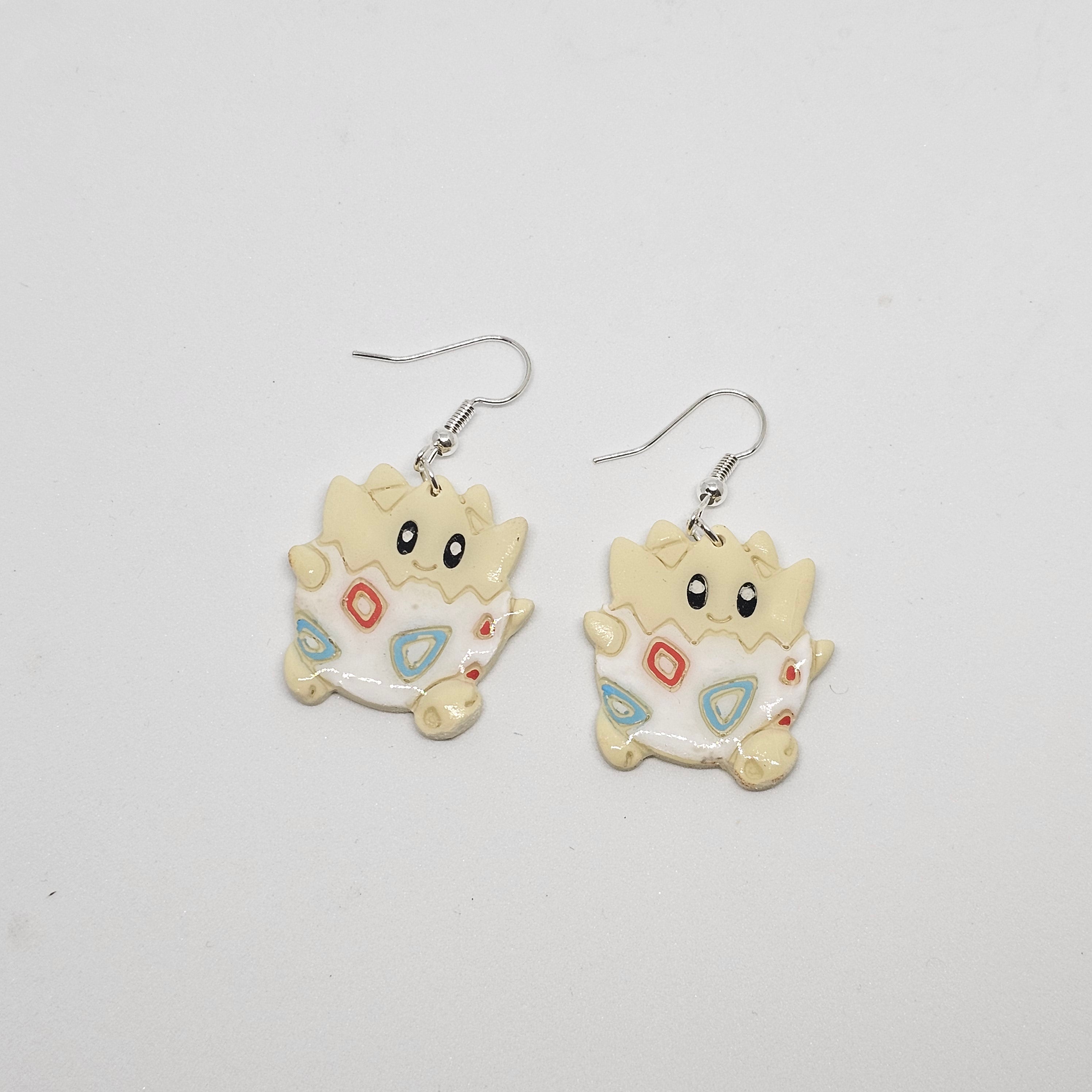 White gold dangle Pokemon Togepi earrings made out of polymer clay.