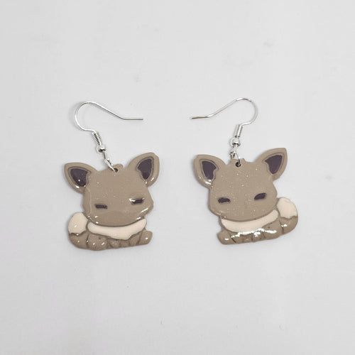 White gold dangle pokemon Eevee earrings made out of polymer clay. 