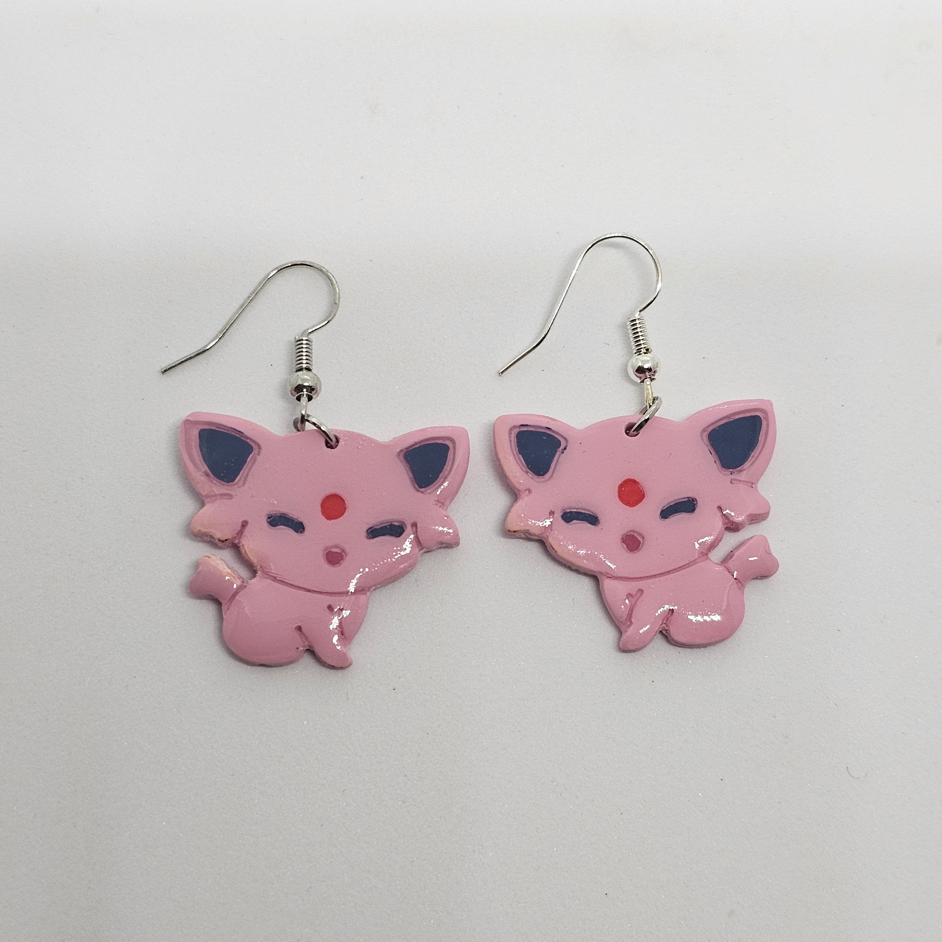 White gold dangle earrings of the Pokemon Espeon made out of polymer clay.