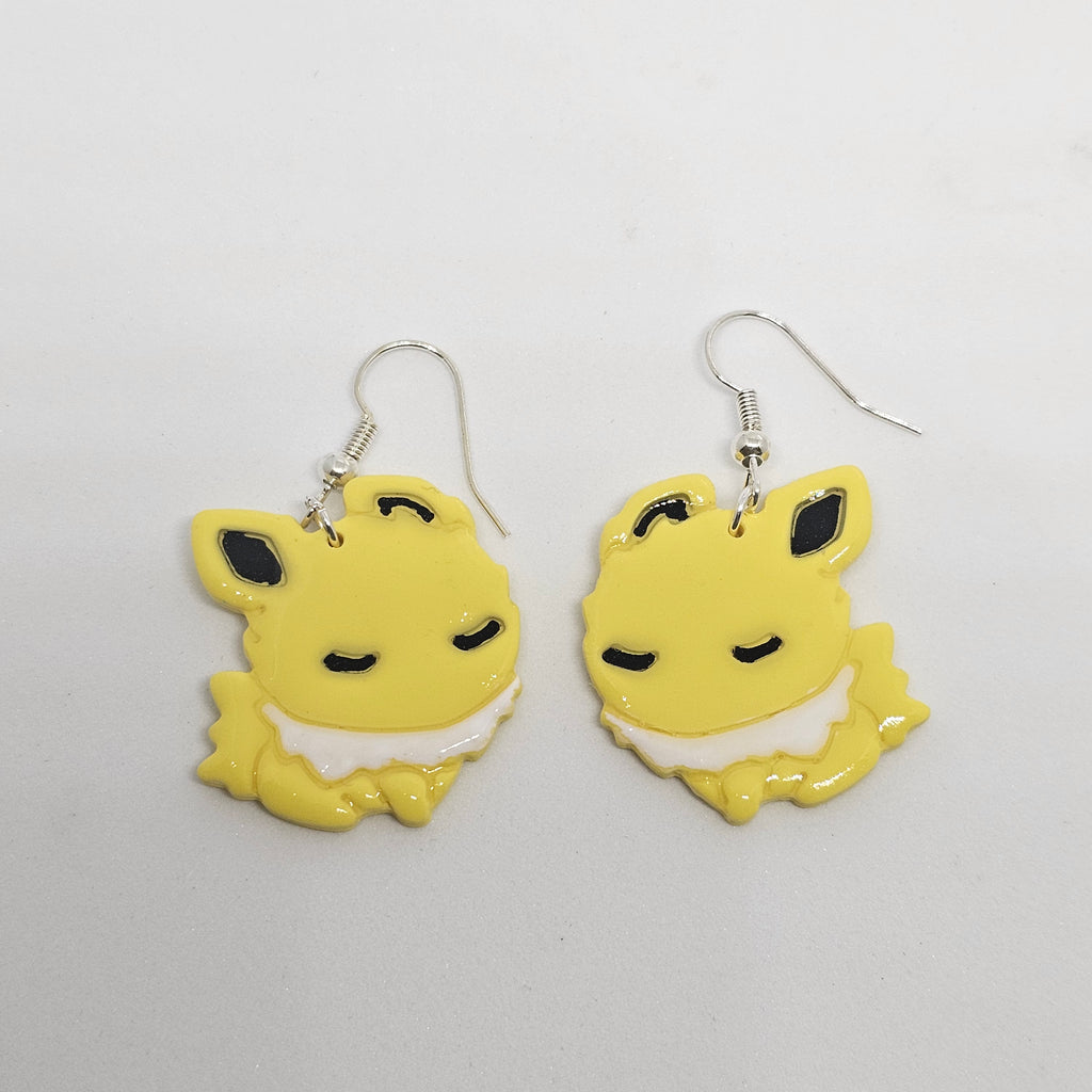 White gold dangle Jolteon pokemon earrings made of polymer clay.