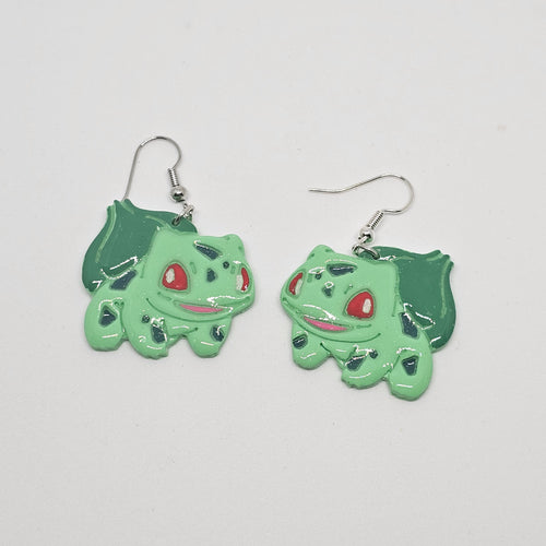 White gold dangle earring with the Pokemon bulbasaur made out of polymer clay. 