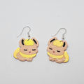 White gold dangle earrings with the pokemon Flareon made out of polymer clay.
