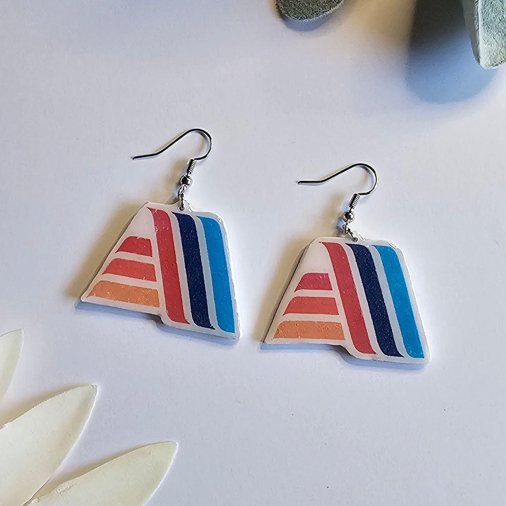 Silver dangle Aldi logo dangle earring on a white background. 
